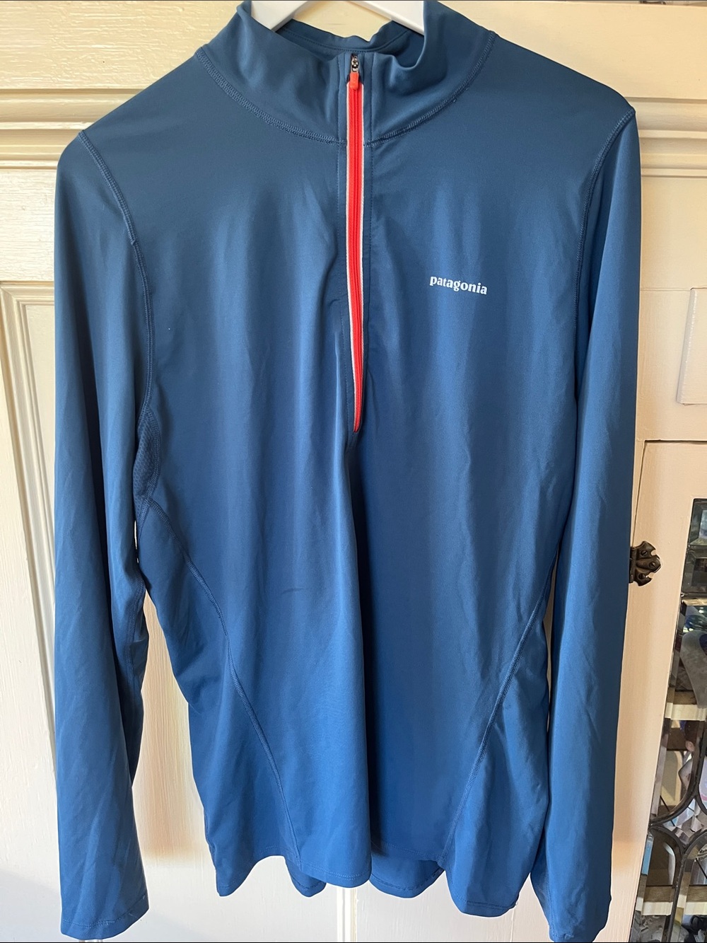Patagonia Men’s Navy Performance 1/4 Zip with snazzy orange Trim.